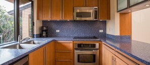 Enjoy cooking in this well-equipped kitchen with a microwave, oven, and coffee maker.