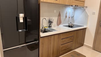 Fridge, electric kettle, cookware/dishes/utensils, spices