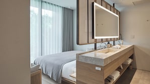 A modern hotel room with a large bed, a wooden vanity with a mirror, and a window with curtains. - TRUNK HOTEL YOYOGI PARK (Tokyo)