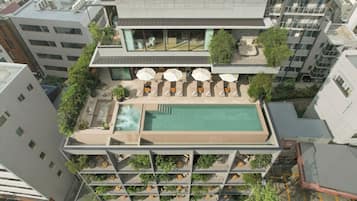 Outdoor pool, open 7:00 AM to 11:00 PM, pool umbrellas