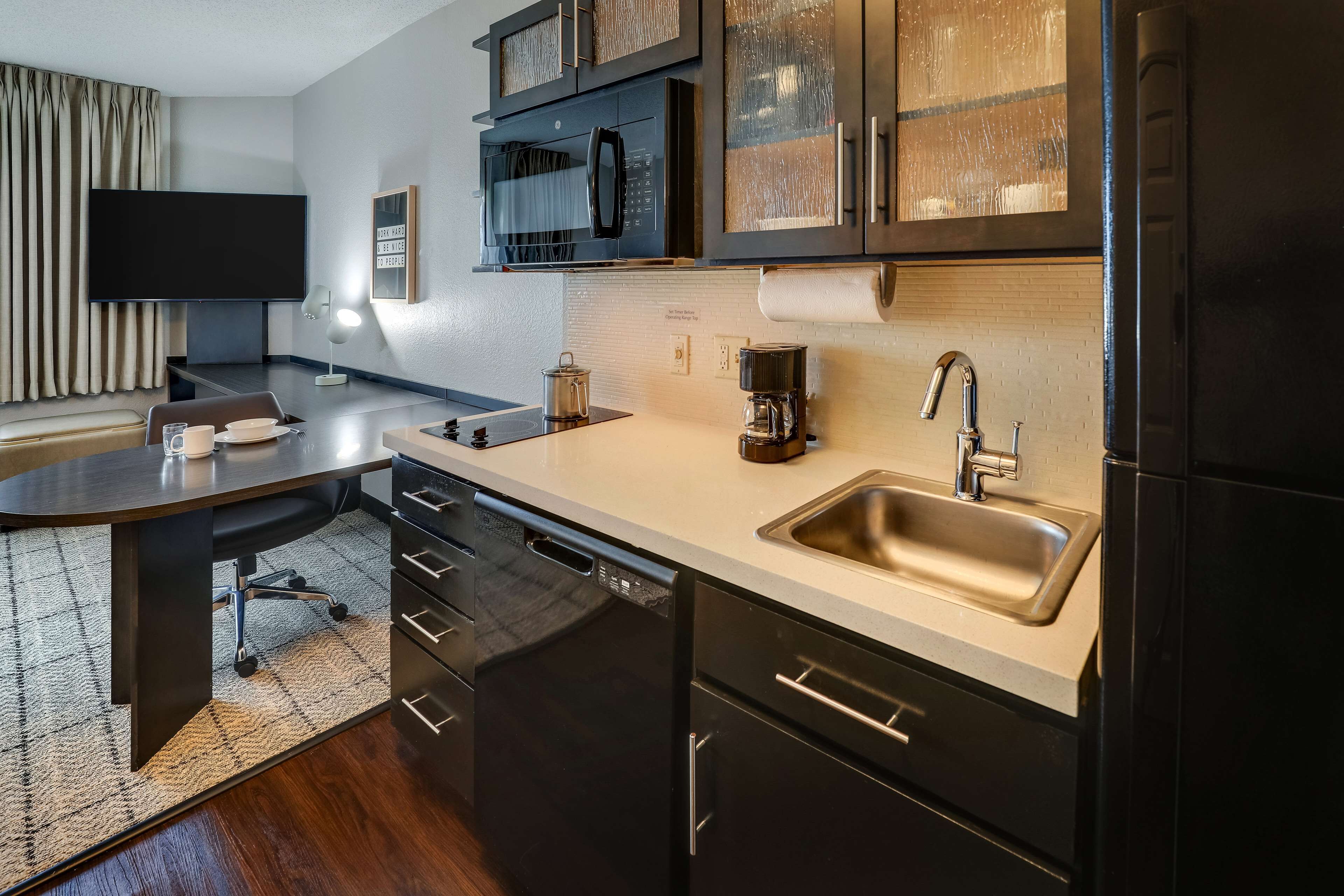 Enjoy simple meals with a sleek kitchenette and bright counters.