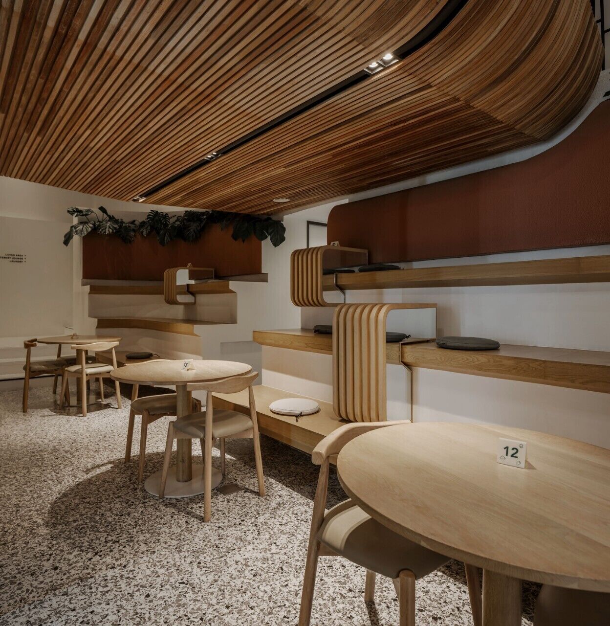 A modern interior with wooden furniture and a unique ceiling design.