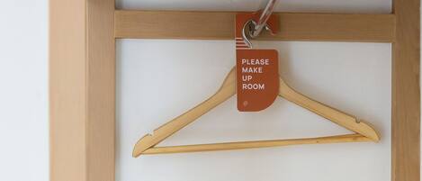 A wooden frame with a white background and a hanger labeled "PLEASE MAKE UP ROOM".