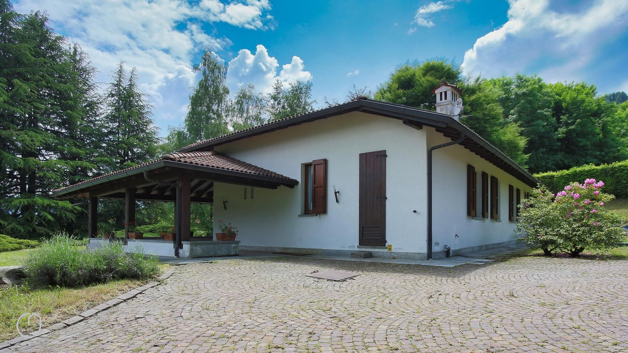 A small, single-story building with a tiled roof and a covered porch.