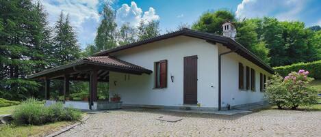 A small, single-story building with a tiled roof and a covered porch.