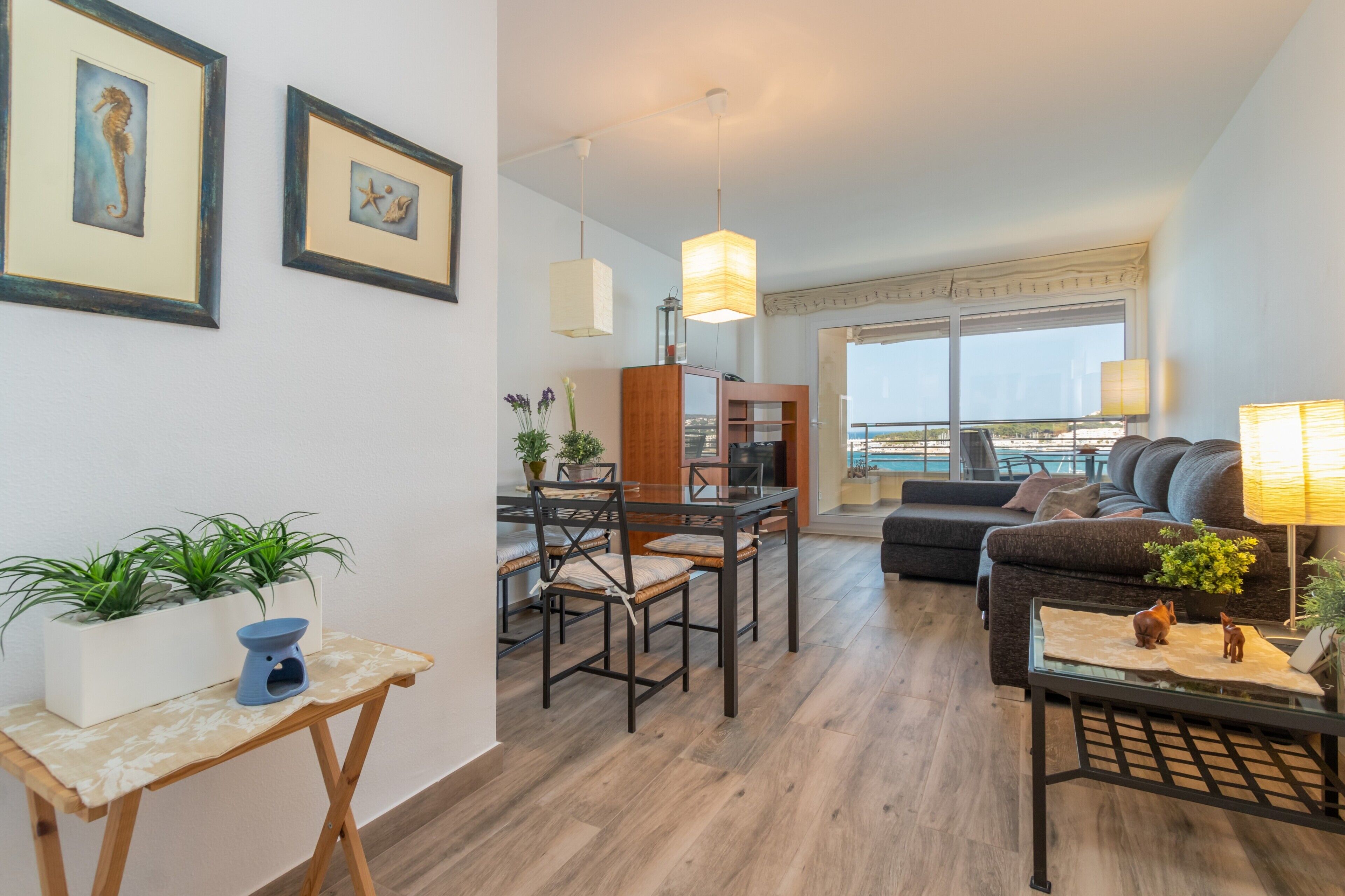 Sala de estar moderna com área de jantar, janelas amplas e varanda com vista.