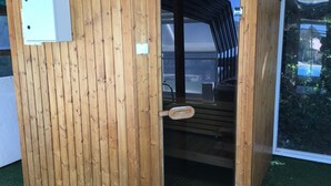 A wooden sauna structure with a door, a small window, and a metal handle. - Holiday Home 'Maison Piscine Chauffe Jacuzzi' with Private Terrace, Private Garden and Wi-Fi (Tourrettes)