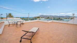 A rooftop terrace with a table and chairs, a pool, and a mountain view. - Holiday Home 'Casa Blanca Family Villa' with Private Pool, Wi-Fi & Air Conditioning (alfaz del pi)
