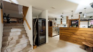 A modern kitchen with a wooden island, a built-in oven, and a refrigerator. - Resort Village Majer - Apartments, Glamping - Slovenia (Gradac)
