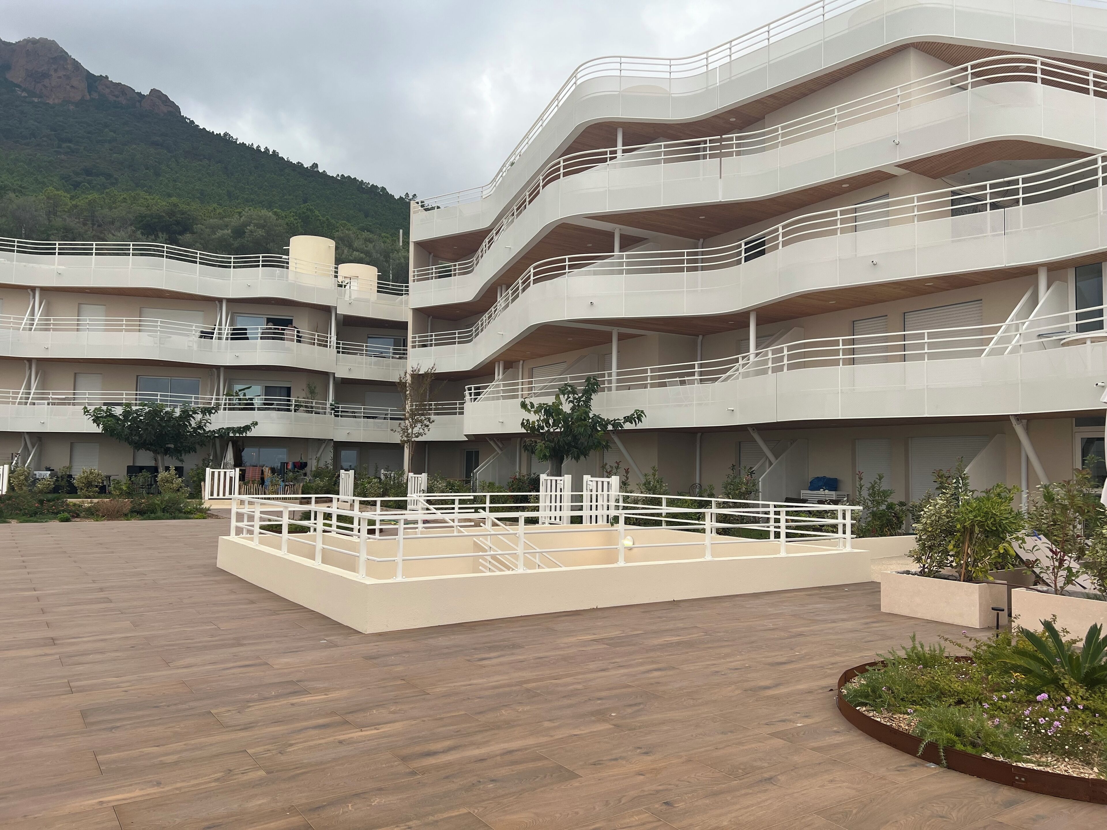 A multi-story building with balconies and a central courtyard.