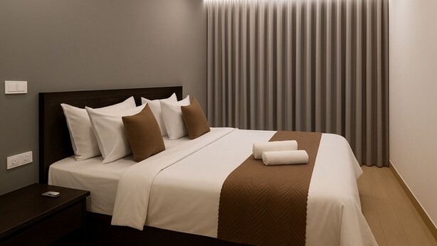 A modern hotel room with a neatly made bed, a bedside table with a phone, and a large window with curtains. - Mauryan Elite Hotel @ Devli Khanpur (New Delhi)