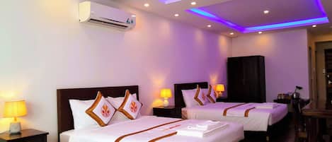 Premium Quadruple Room, 1 Bedroom, City View | Minibar, desk, laptop workspace, blackout drapes