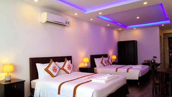 Premium Quadruple Room, 1 Bedroom, City View | Minibar, desk, laptop workspace, blackout drapes