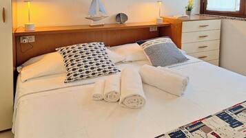 Relax in comfort with a neatly made bed, adorned with crisp linens and a decorative pillow.