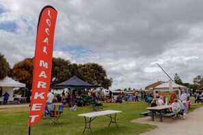 An outdoor market with tents and tables set up for vendors.