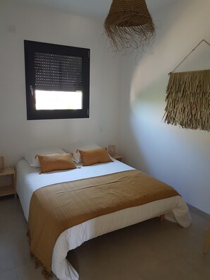Relax in a serene bedroom with a large bed and a window offering a view.