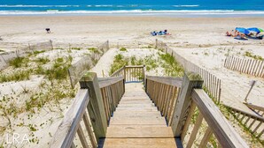 A wooden boardwalk leading to a sandy beach with ocean views. - Mermaid Cove – Splash Into Relaxation (North Topsail Beach)