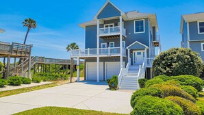 A two-story beachfront house with a balcony, a covered porch, and a wooden deck. - Mermaid Cove – Splash Into Relaxation (North Topsail Beach)