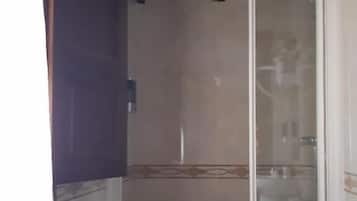 A bathroom with a shower, toilet, and sink.
