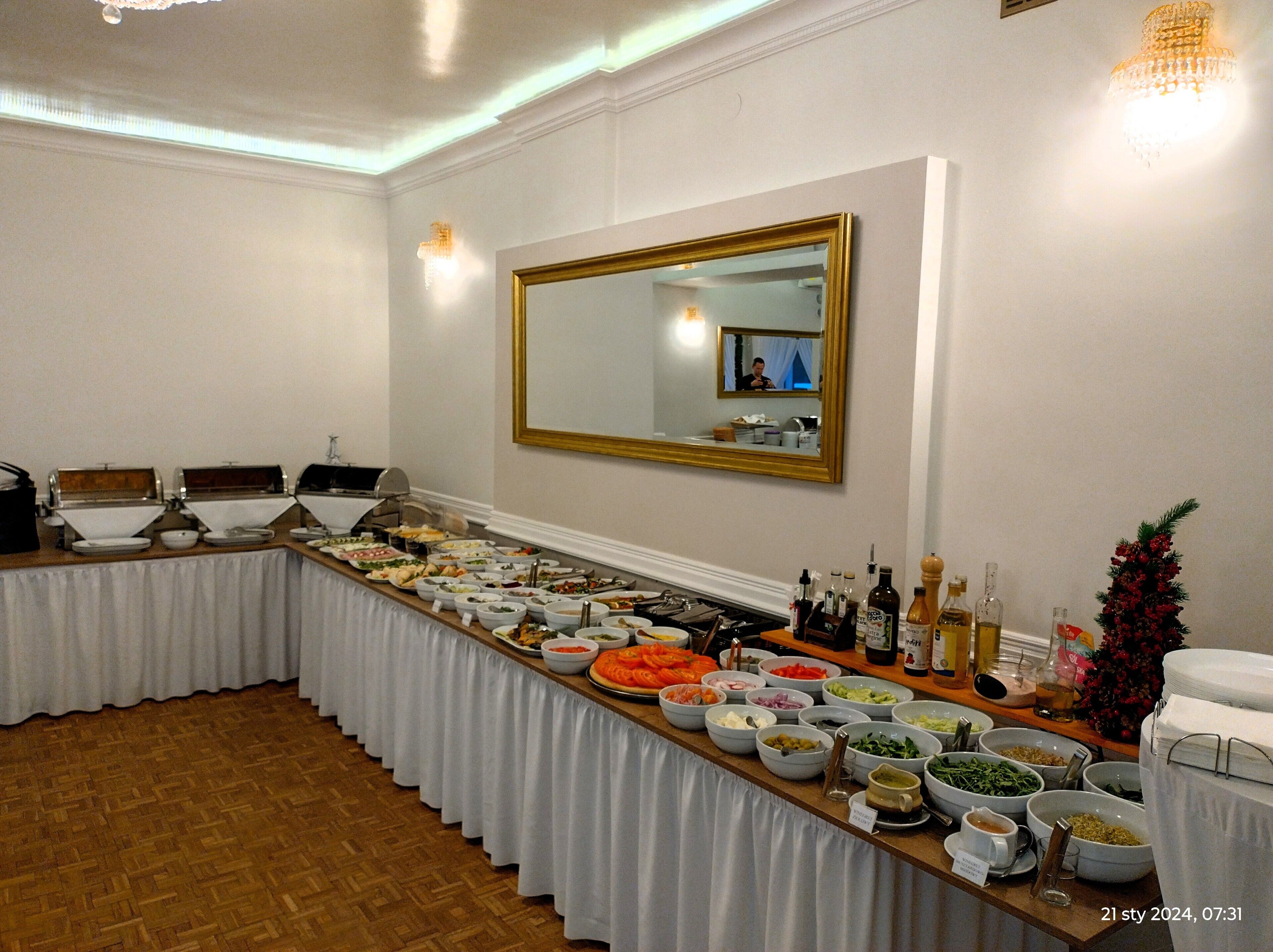A buffet setup with various food items and condiments.
