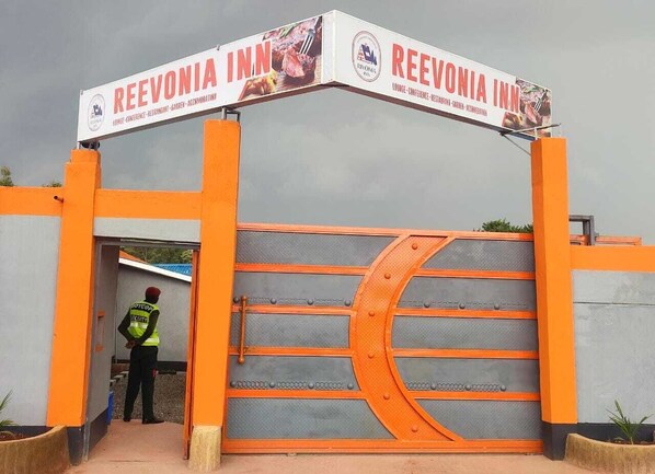 The entrance to ReeVonia Inn with a security guard standing at the gate. - Reevonia Inn  (Kapsabet)