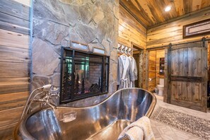 Bathtub, hair dryer, towels, toilet paper
