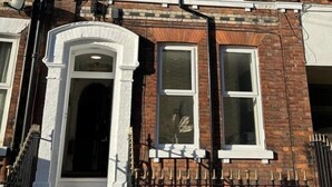 A multi-story brick building with white-framed windows and a central entrance with steps. - Apartment 4 - The Crescent (York)