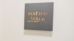 A sign with the text "MARINA WALK" in gold lettering on a grey background. - Marina Walk, New Luxury Coastal Apartment in The English Riviera (Torquay)