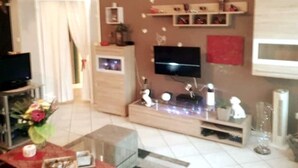 A living room with a television, a flat-screen TV, a microwave, and a cabinet. - Komfortable Wohnung Zentral zur City(5km) Eifel(10km)
Belgien(2km)Holland(12km) (Aachen)