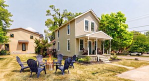 A two-story house with a front porch, a fire pit, and outdoor seating. - Historic Downtown Plymouth Home in Old Village (Plymouth)