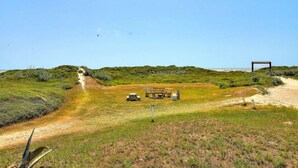 A campsite with a picnic table, a bench, and a tent. - Beachgate Condo Suites And Hotel 231+233 2 Bedroom Condo (Port Aransas)