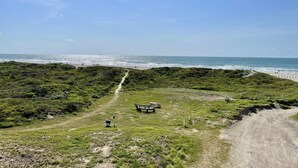 A coastal path with a bench and picnic table, leading to a beach. - Beachgate Condo Suites And Hotel 231+233 2 Bedroom Condo (Port Aransas)