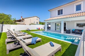 A modern house with a swimming pool, outdoor seating, and a patio area. - Villa Mateo - modern villa with private pool near the beach (Pula)