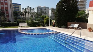 A swimming pool with a tiled edge and a metal ladder. - Don Ximo 13º  Solo Familias! (Playa de Gandía)