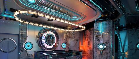 A futuristic interior with a central circular design, a glass table, and ambient lighting.