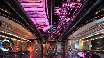 A futuristic interior with reflective surfaces and ambient lighting.