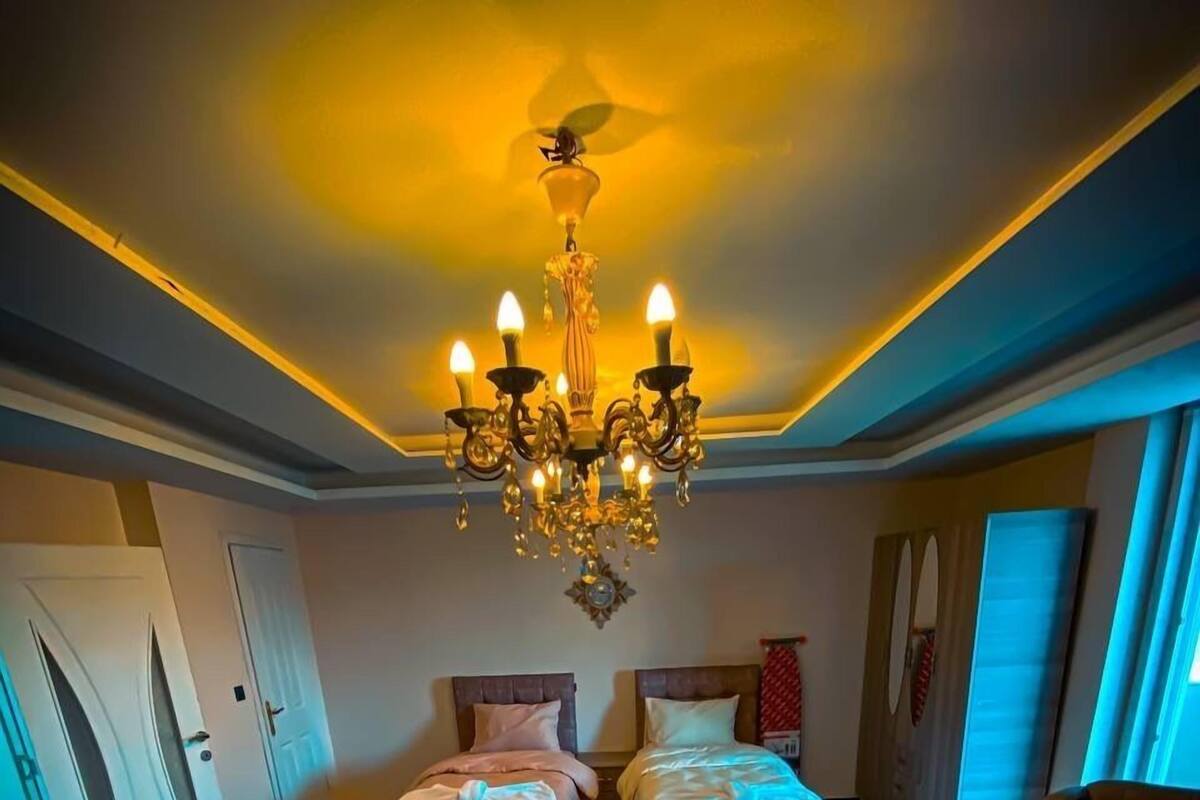 A spacious bedroom with a large bed, a sofa, and a coffee table.