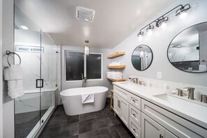 Bathtub, hair dryer, towels, shampoo