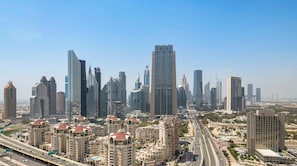 A cityscape with modern high-rise buildings, a highway, and a mix of residential and commercial structures.