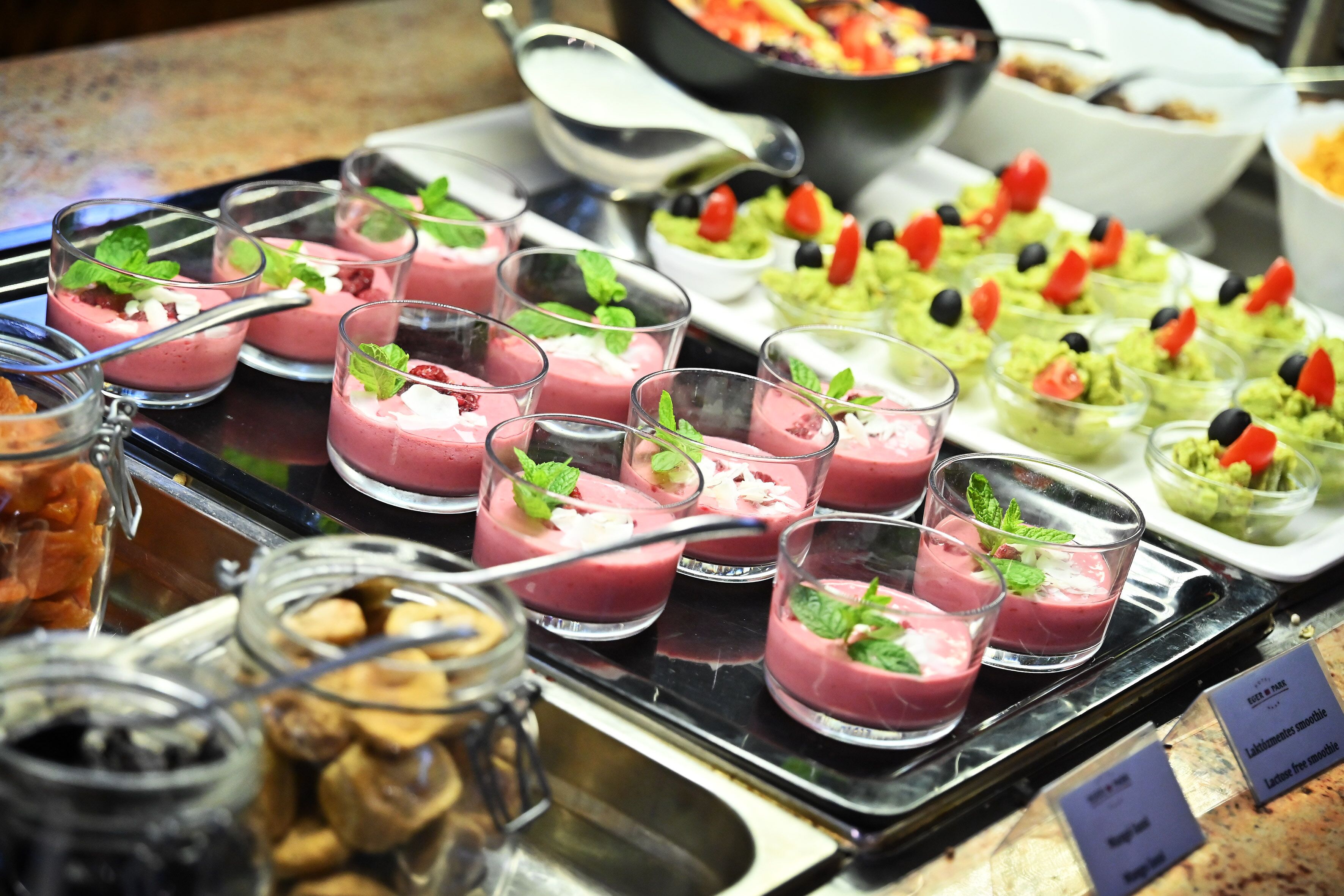 A buffet with various food items including smoothies, guacamole, and other dishes.