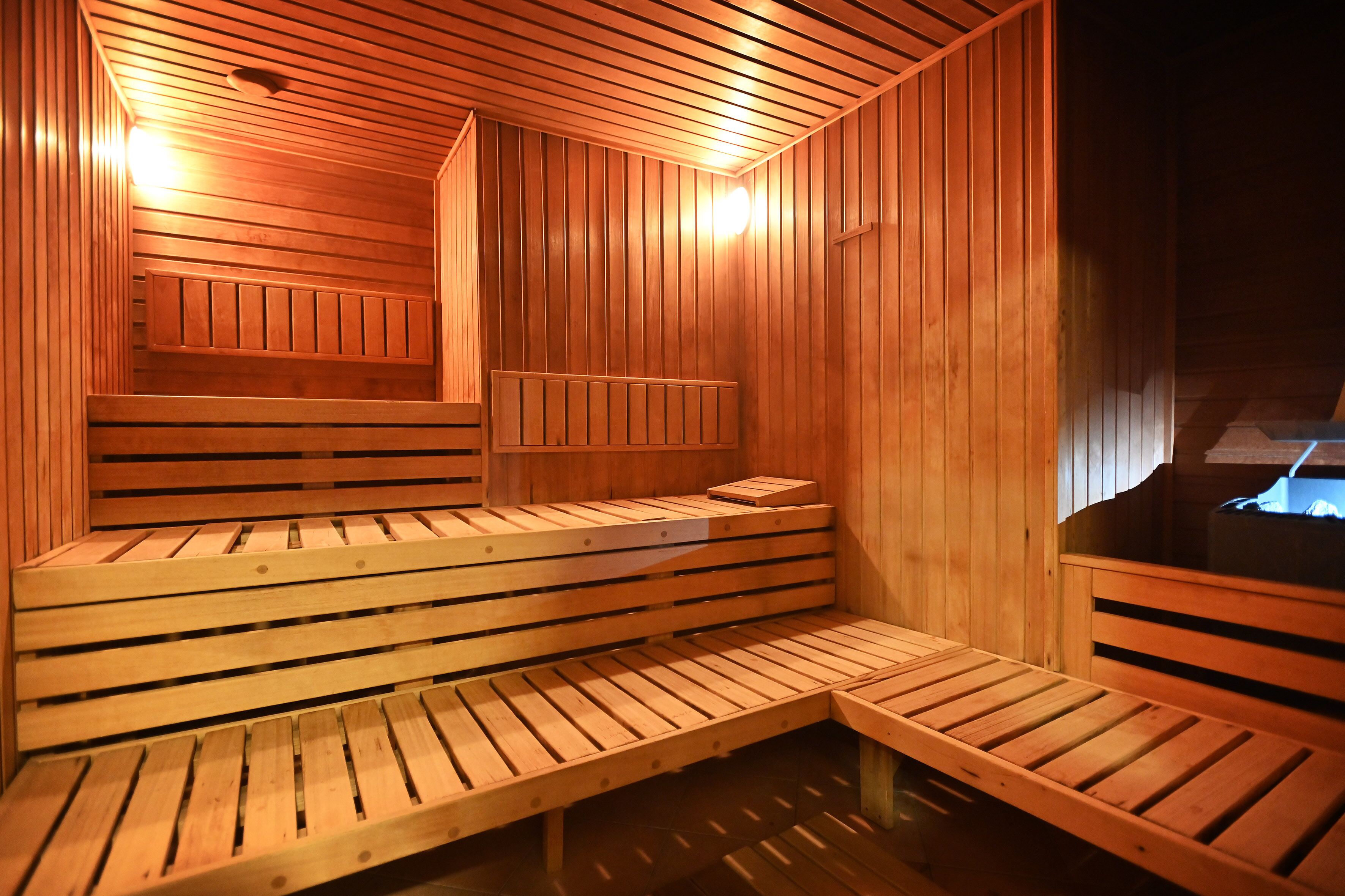 A wooden sauna with benches and a bench seat.