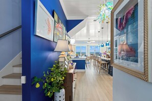 Een moderne keuken met uitzicht op de oceaan, blauwe wanden en een trap.