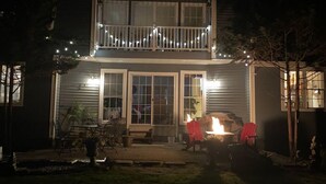 A two-story house with a balcony, a fire pit, and outdoor seating. - Privacy yet close to downtown Saratoga (Greenfield Center)