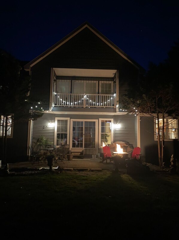 A two-story house with a balcony, a fire pit, and outdoor seating. - Privacy yet close to downtown Saratoga (Greenfield Center)
