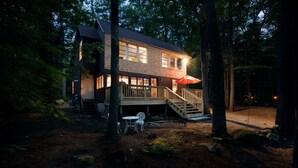 A two-story wooden cabin with a deck and outdoor seating area, surrounded by trees. - Pine and Eagle- Family & Dog Friendly Great Views (Sebago)