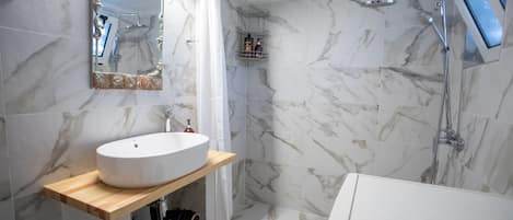 Bathtub, hair dryer, towels, toilet paper