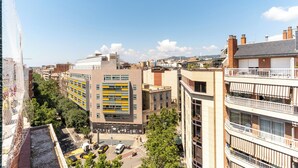 A multi-story building with a modern architectural design, featuring a mix of residential and commercial spaces. - Penthouse With Private Terrace (Barcelona)