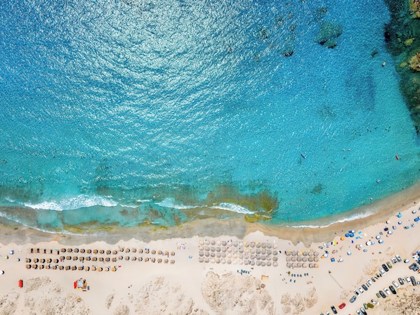 Beach nearby, white sand, sun loungers, beach umbrellas