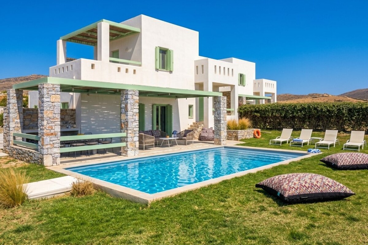 A modern two-story house with a swimming pool, stone pillars, and outdoor seating.