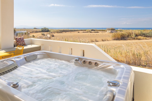 A hot tub with a view of the sea and dry fields. - Plioni- Villas With Private Pool & Suites With Hot Tub (Naxos)